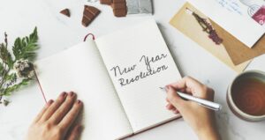 A notebook with the words New Year Resolution written on it to encourage people to volunteer
